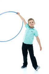 A little boy is playing with a hoop.
