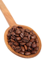 Coffee beans on wooden spoon. Isolated with clipping path.