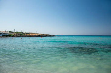 Fototapeta na wymiar The most famous beach of Cyprus with crystal clear water. Nissi Beach.