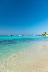 The most famous beach of Cyprus with crystal clear water. Nissi Beach.