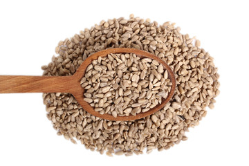Sunflower seeds on wooden spoon. Isolated on white background. Directly Above.