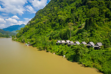 Obraz premium Aerial view of mountains and river Nong Khiaw. North Laos. Southeast Asia. Photo made by drone from above. Bird eye view.