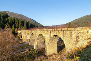 Antique viaduct type railway bridge in the mountains.