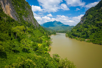 Fototapeta na wymiar Aerial view of mountains and river Nong Khiaw. North Laos. Southeast Asia. Photo made by drone from above. Bird eye view.