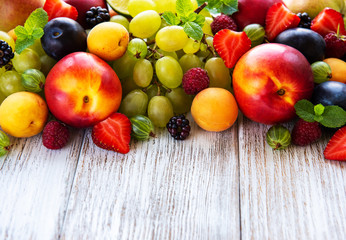 Fresh summer fruits and berries on a white wooden table