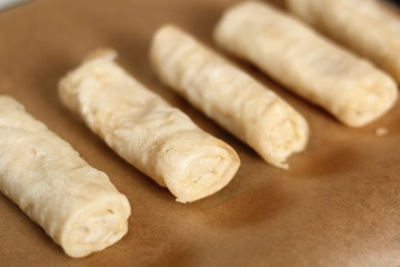 Raw spring roll on baking tray