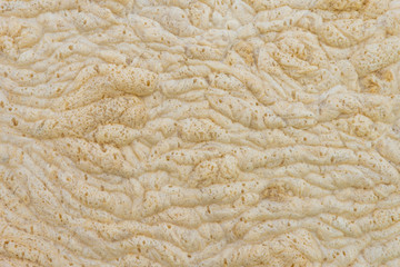 Background of yellow foam on the water