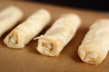 Raw spring roll on baking tray