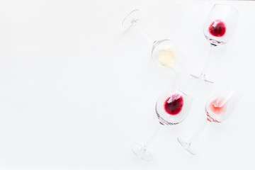 Glasses with different wine bordeaux, red, rose and white on white background. Beautiful wine variety concept.