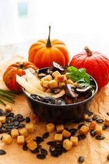 Pumpkin soup garnish with mushroom, seeds and croutons