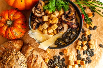 Pumpkin soup garnish with mushroom, seeds and croutons