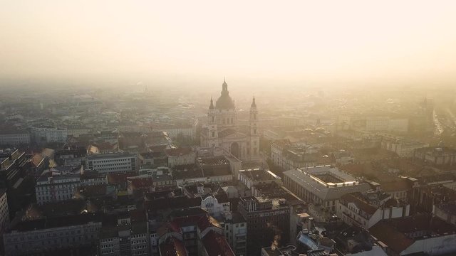 Top view shooting on a drone in the early morning. City is the capital of Hungary,   sunrise of the sun. Historical part of the old city Budapest, towers St. Stephen's Cathedral.