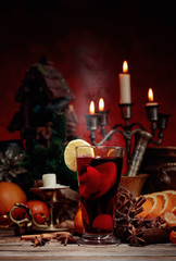 Mulled wine and Christmas decorations with candlesticks.