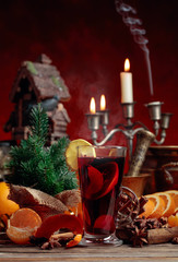 Mulled wine and Christmas decorations with candlesticks.