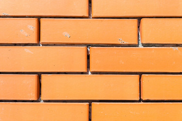 Fototapeta premium Textured background new brickwork close-up orange brick