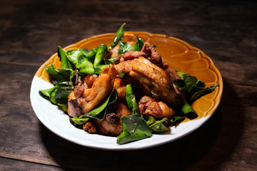 Deep fried chickens with herbs rustic local food Thai style. Fried chicken on wood table background.
