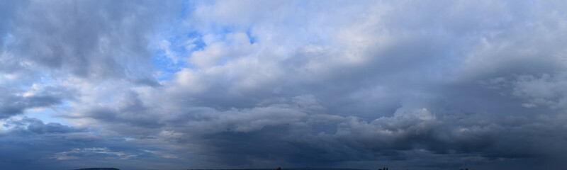 Fototapeta na wymiar Heavy rain clouds. Photography, atmospheric phenomena, panoramic image of the autumn sky.