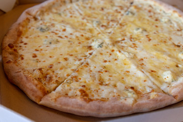 Pizza 4 cheese closeup background of junk food of soft focus with copy space.