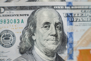 Obraz na płótnie Canvas Macro close up of Ben Franklin's face on the US one hundred dollar bill