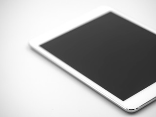 Closeup of white tablet with black touch screen display on gray background.
