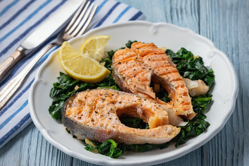 Grilled rainbow trout fillet, served with spinach.