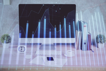 Forex graph hologram on table with computer background. Double exposure. Concept of financial markets.