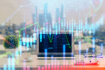 Forex Chart hologram on table with computer background. Double exposure. Concept of financial markets.