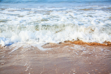 Beautiful tropical beach and sea with foam waves in paradise place.