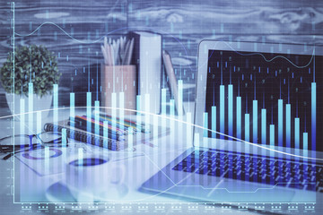 Forex market chart hologram and personal computer background. Multi exposure. Concept of investment.