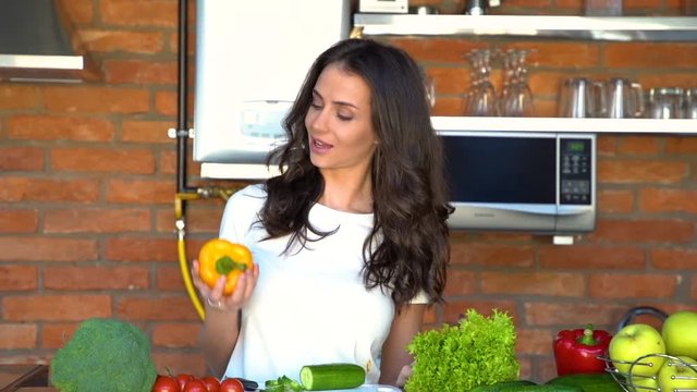 Young pretty woman holding papper for salad in the kitchen at home