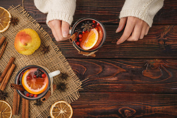 Hot muilled wine in woman's hands close up