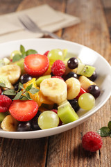 fresh fruit salad on wood background