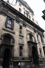Obraz premium Closeup of Dominican Church in Lviv. Old building with staircase. Entrance Stairs The Door Old. Door to the Catholic Church. Stairs to the Church
