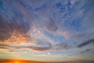 Dramatic sunset sky with orange clouds.