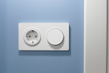 Socket and round switch in one common frame