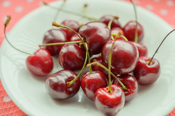 Cherry on the table in a cup. Selective focus.