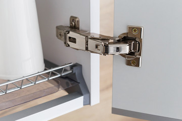 Door hinge of cabinet for drying dishes. - obrazy, fototapety, plakaty