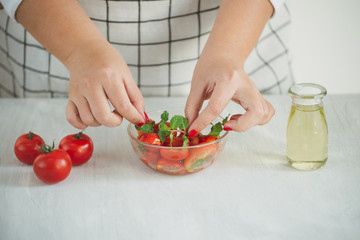 Fresh delicious salad with tomatoes. Doing fresh green salad