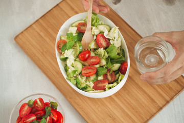 Healthy food and diet menu. Various fresh mix salad with tomato, cucumber, onion