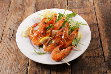 fried shrimp skewer on wood background