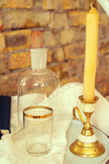 Obraz na płótnie Canvas Golden candlestick and glass on the table