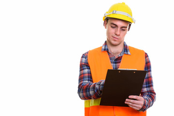 Portrait of young handsome man construction worker holding clipboard