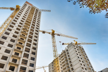 Construction site with buildings and industrial cranes