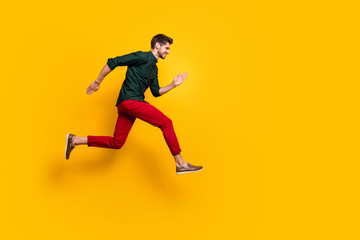 Fototapeta na wymiar Full body profile side photo of positive cheerful funky guy hear about wonderful black friday sales jump run want be first wear casual style outfit isolated over yellow color background