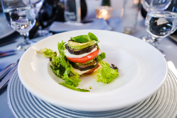 Restaurant dish - salad with tomato, eggplant, mozarella cheese and basil