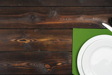 Table setup with plates on dark wooden background