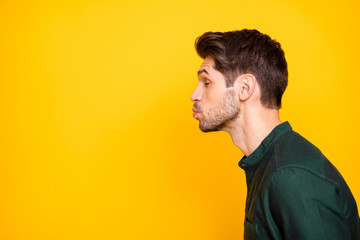 Side profile photo of tender man full of feelings pouting his lips to kiss empty space next to him...