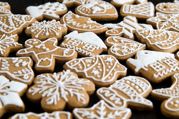 Christmas gingerbread of different kinds on a black and white wooden background