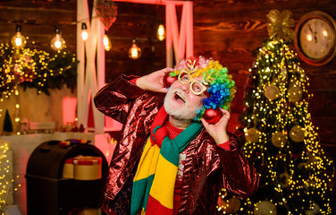 having fun. xmas gifts. Time for presents. christmas tree decoration. Going crazy. happy man with beard. mature bearded freak. party man in clown wig. new year weekend. Fanily holiday