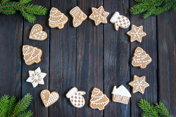 Christmas gingerbread of different kinds on a black and white wooden background